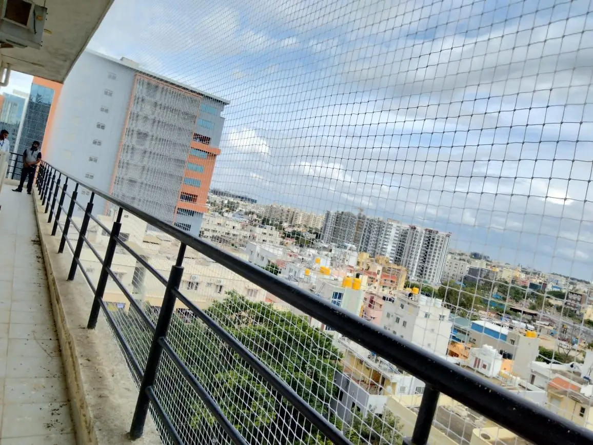 Technician measuring balcony before net installation